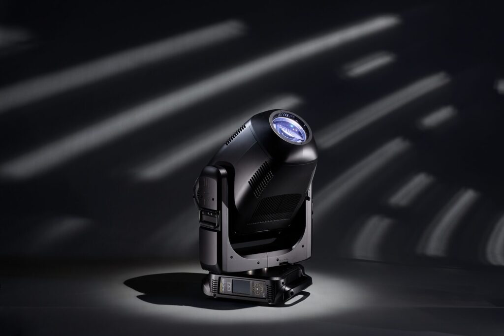 ETC’s Halcyon Silent a moving head fixture shown in dramatic lighting with a swoosh of angled bars of lights in the background 