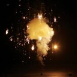 Le Maitre Pyroflash pyrotechnics stage effect falling gold sparks surround a cloud of smoke